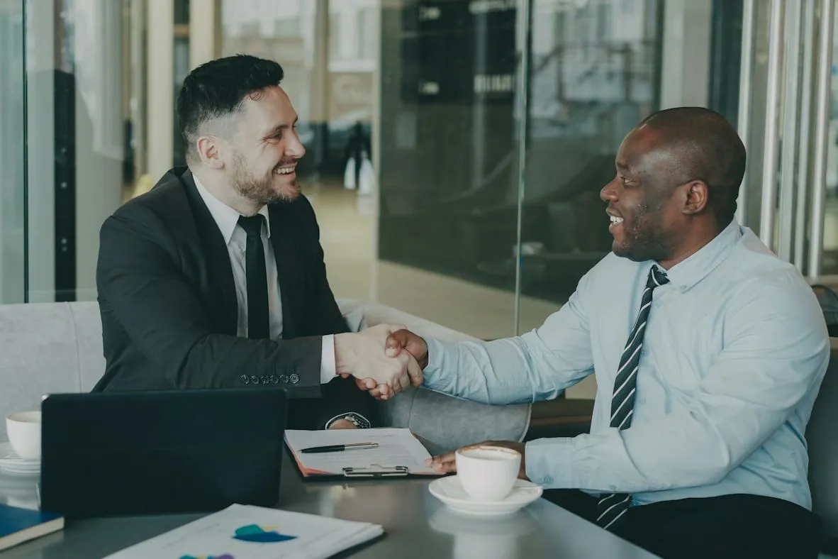 Handshake across a table